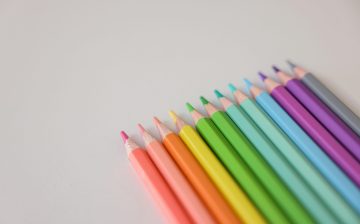A close-up of colorful sharpened pencils arranged on a white surface, perfect for art themes.